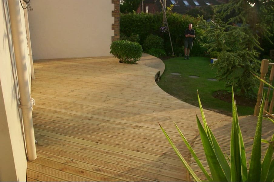 Green Treated Decking In A Landscaped Garden